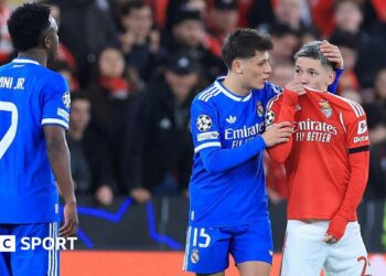 SL Benfica's Argentine forward Gianluca Prestianni hides his mouth while arguing with Real Madrid's Brazilian forward Vinicius Junior