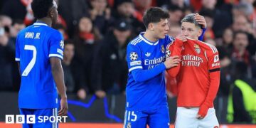 SL Benfica's Argentine forward Gianluca Prestianni hides his mouth while arguing with Real Madrid's Brazilian forward Vinicius Junior