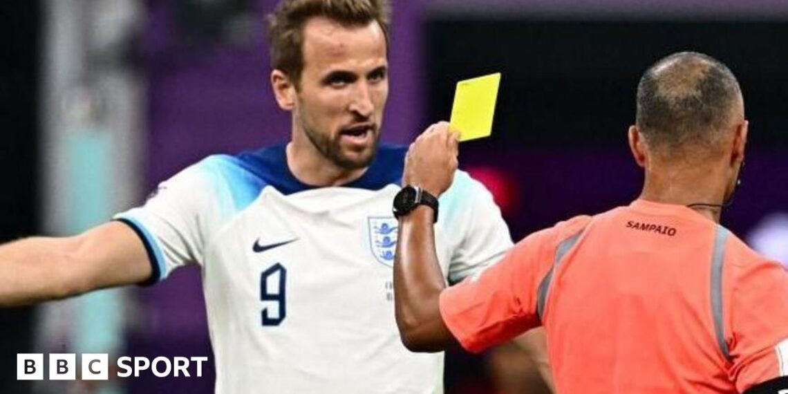 Harry Kane argues with Brazilian referee Wilton Sampaio as he shows a yellow card
