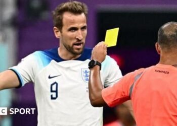 Harry Kane argues with Brazilian referee Wilton Sampaio as he shows a yellow card