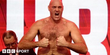 Tyson Fury tenses for the cameras at the weigh-in
