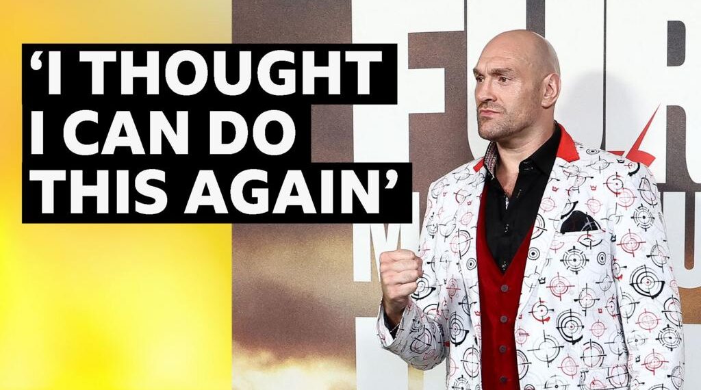 Tyson Fury at a press conference ahead of his fight on Saturday. He is wearing a white suit jacket.