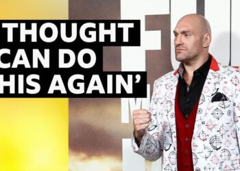 Tyson Fury at a press conference ahead of his fight on Saturday. He is wearing a white suit jacket.