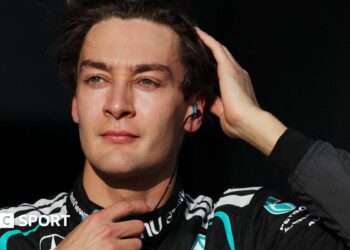 George Russell runs his right hand through his hair as he prepares for the start of the 2026 Japanese Grand Prix
