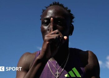 Australian sprinter Gout Gout puts his finger to his lips and makes a '1' sign after his win