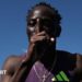Australian sprinter Gout Gout puts his finger to his lips and makes a '1' sign after his win