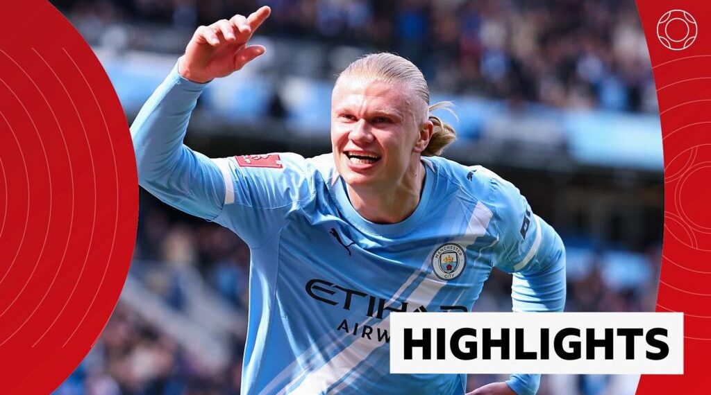 Erling Haaland of Manchester City smiles and celebrates his goal with one arm in the air