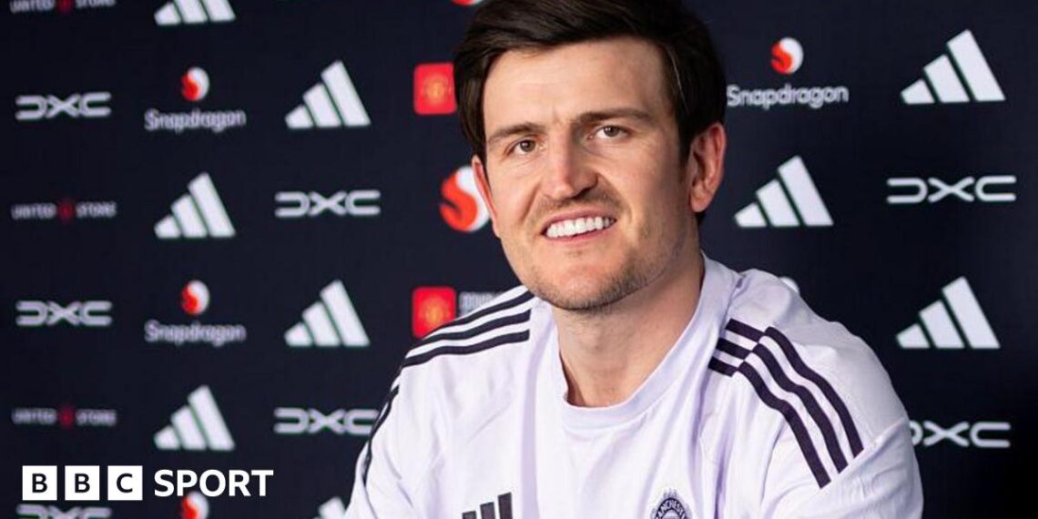 Harry Maguire smiling in a Manchester United news conference