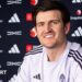 Harry Maguire smiling in a Manchester United news conference