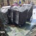 Huge containers of liquid waste dumped by roadside