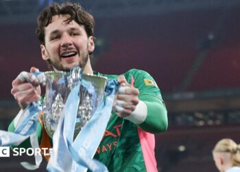 James Trafford holds the Carabao Cup trophy