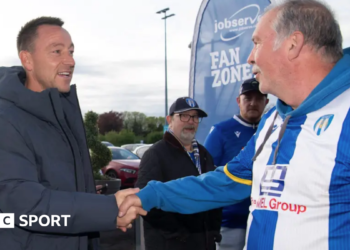 John Terry shakes hands with a Colchester fan