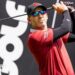 Sergio Garica tees off during a LIV Golf tournament with the branding in the background