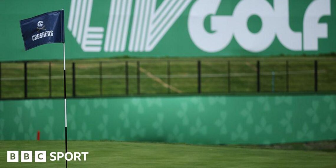A flag on a golf course green in front of a sign that says 'LIV Golf'