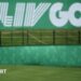 A flag on a golf course green in front of a sign that says 'LIV Golf'