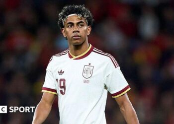 Lamine Yamal wearing a white Spain shirt