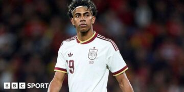 Lamine Yamal wearing a white Spain shirt