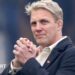 Lewis Moody smiles while clasping his hands
