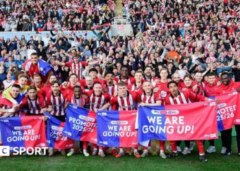 The Lincoln City squad celebrating their promotion infront of their visiting supporters at Reading's Select Car Leasing Stadium.