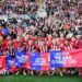 The Lincoln City squad celebrating their promotion infront of their visiting supporters at Reading's Select Car Leasing Stadium.