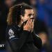 Marc Cucurella pulls his shirt up over his mouth after defeat at Brighton