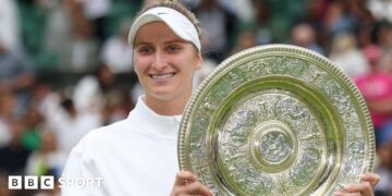 Marketa Vondrousova holding the Wimbledon trophy after winning the women's title in 2023