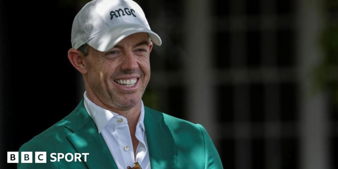 Rory McIlroy smiles as he talks to Augusta officials on his return to the Masters