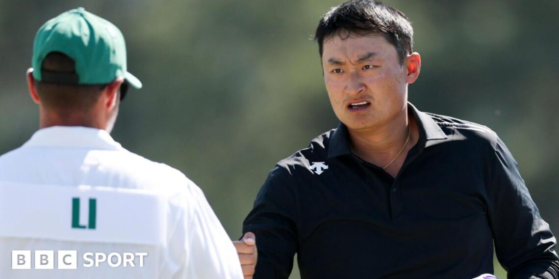 Li Haotong fist bumps his caddie at the 2026 Masters