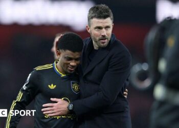 Manchester United winger Amad Diallo (left) with head coach Michael Carrick