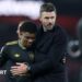 Manchester United winger Amad Diallo (left) with head coach Michael Carrick