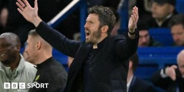 Man Utd manager Michael Carrick holds his arms out