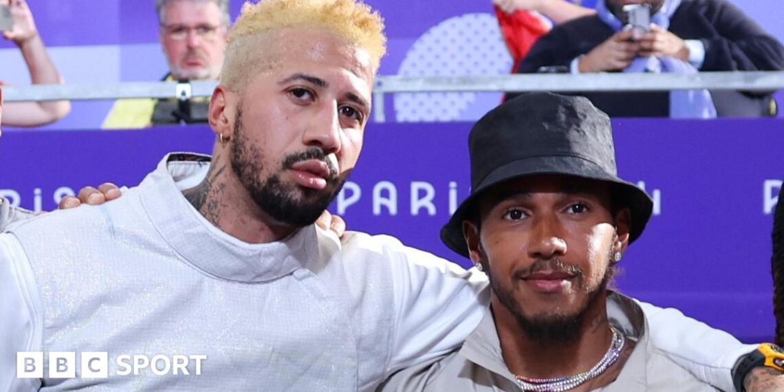 Miles Chalmley-Watson with his arm around Lewis Hamilton