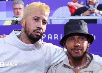 Miles Chalmley-Watson with his arm around Lewis Hamilton