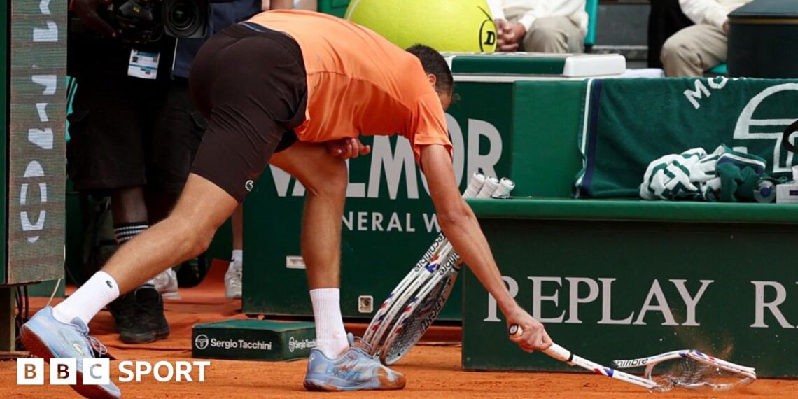 Daniil Medvedev smashes his racquet