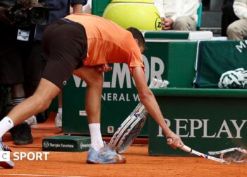Daniil Medvedev smashes his racquet