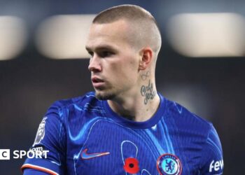 Mykhailo Mudryk looking to his right while playing in a Chelsea kit