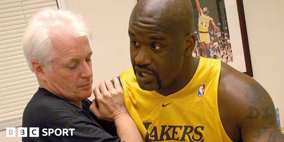 Alex McKechnie doing some physio with Shaquille O'Neal