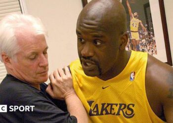 Alex McKechnie doing some physio with Shaquille O'Neal