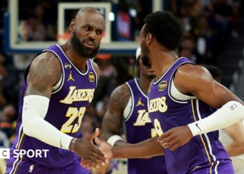 LeBron James and son Bronny on court for LA Lakers against Golden State Warriors