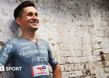 Michal Kwiatkowski models the new Netcompany-Ineos Cycling Team jersey