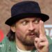 Oleksandr Usyk holds up his finger while speaking