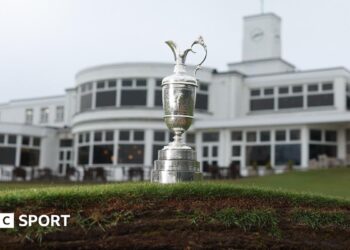 The Claret Jug photographed on top of a bunker in front of the Royal Birkdale clubhouse