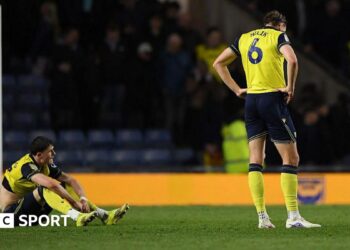 Oxford players Will Lankshear and Michal Helik look disconsolate following their defeat by Wrexham