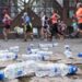 Discarded plastic bottles on the side of a marathon course