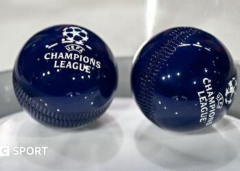 Two dark blue draw balls with the Uefa Champions League logo