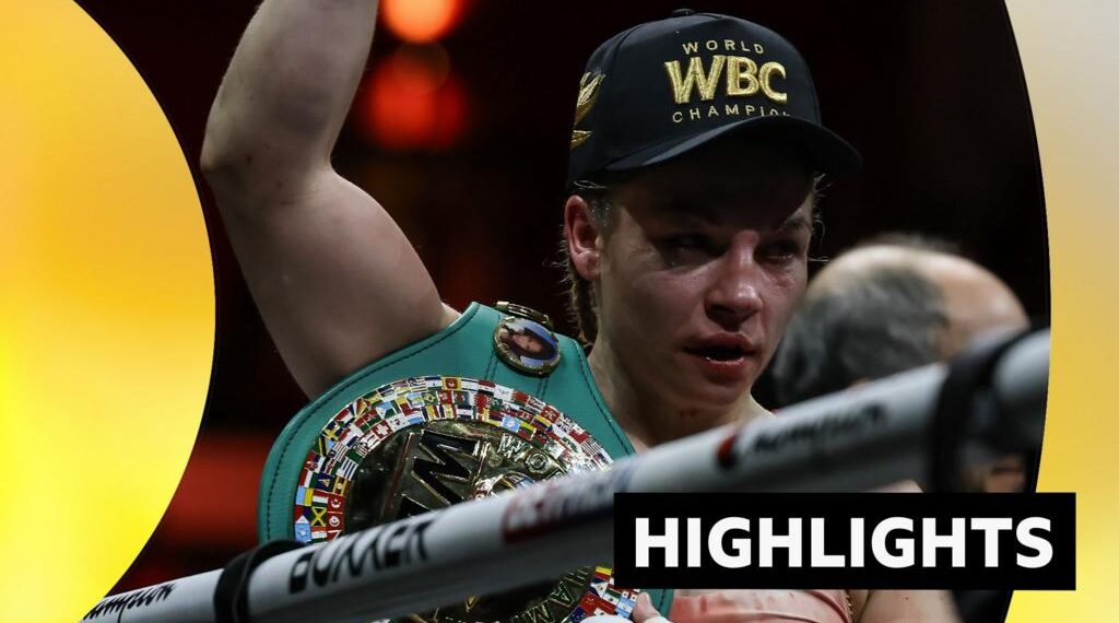 Lauren Price face is bruised after beating Stephanie Pineiro. She holds arm up and wears a WBC champion cap.