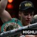 Lauren Price face is bruised after beating Stephanie Pineiro. She holds arm up and wears a WBC champion cap.