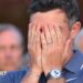 Rory McIlroy covers his face with his hands