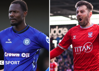 Rochdale striker Emmanuel Dieseruvwe (left) in his side's blue home shirt and York City's Ollie Pearce (right) in his team's red home jersey