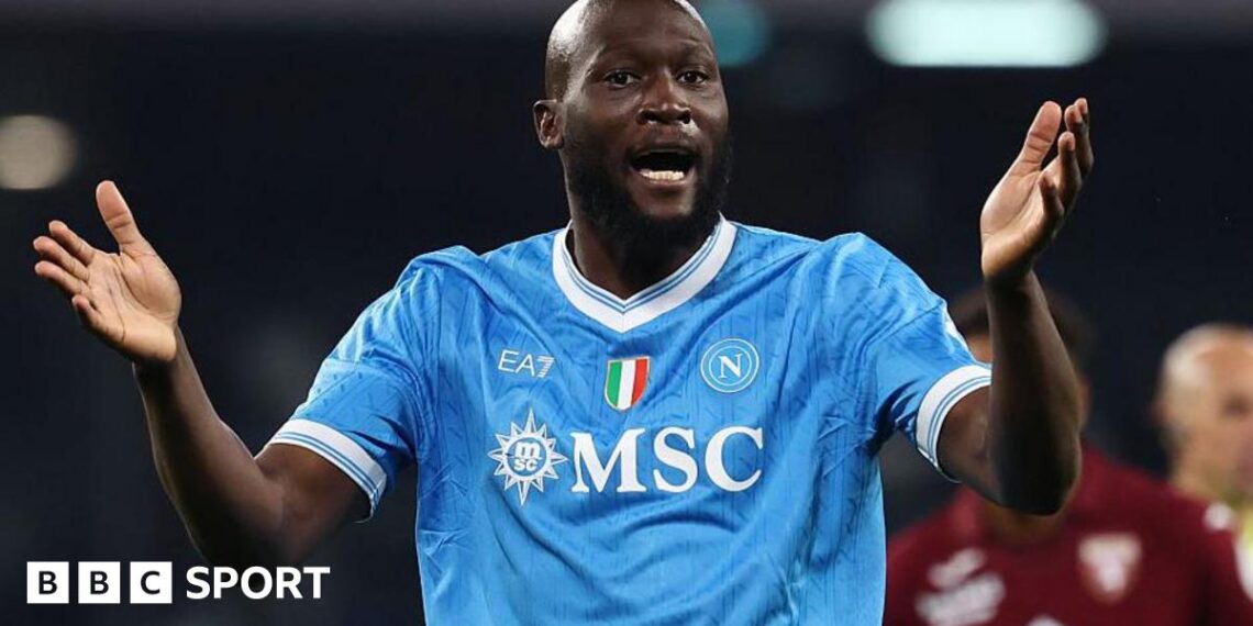 Romelu Lukaku in Napoli's light blue shirt, with raised arms held out in front of him